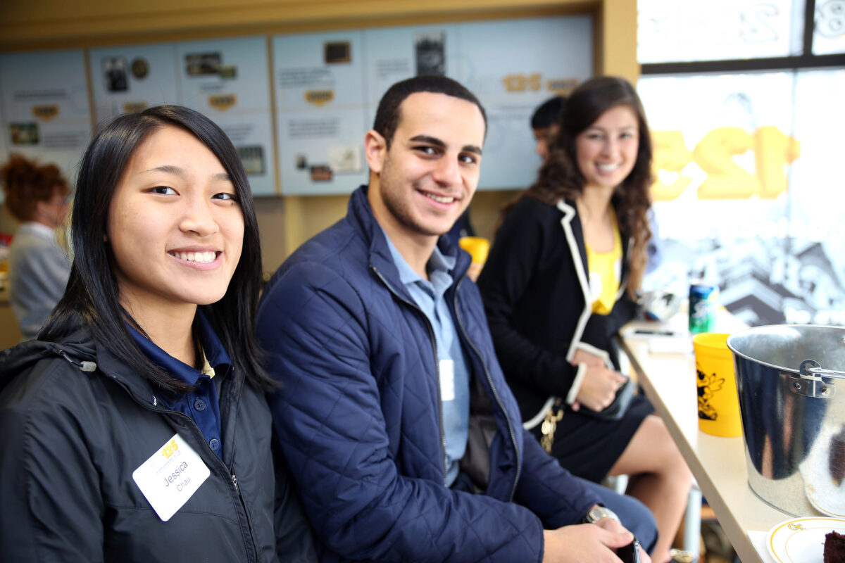 Young alumni enjoying a football game in the Woodruff School suite at Bobby Dodd Stadium